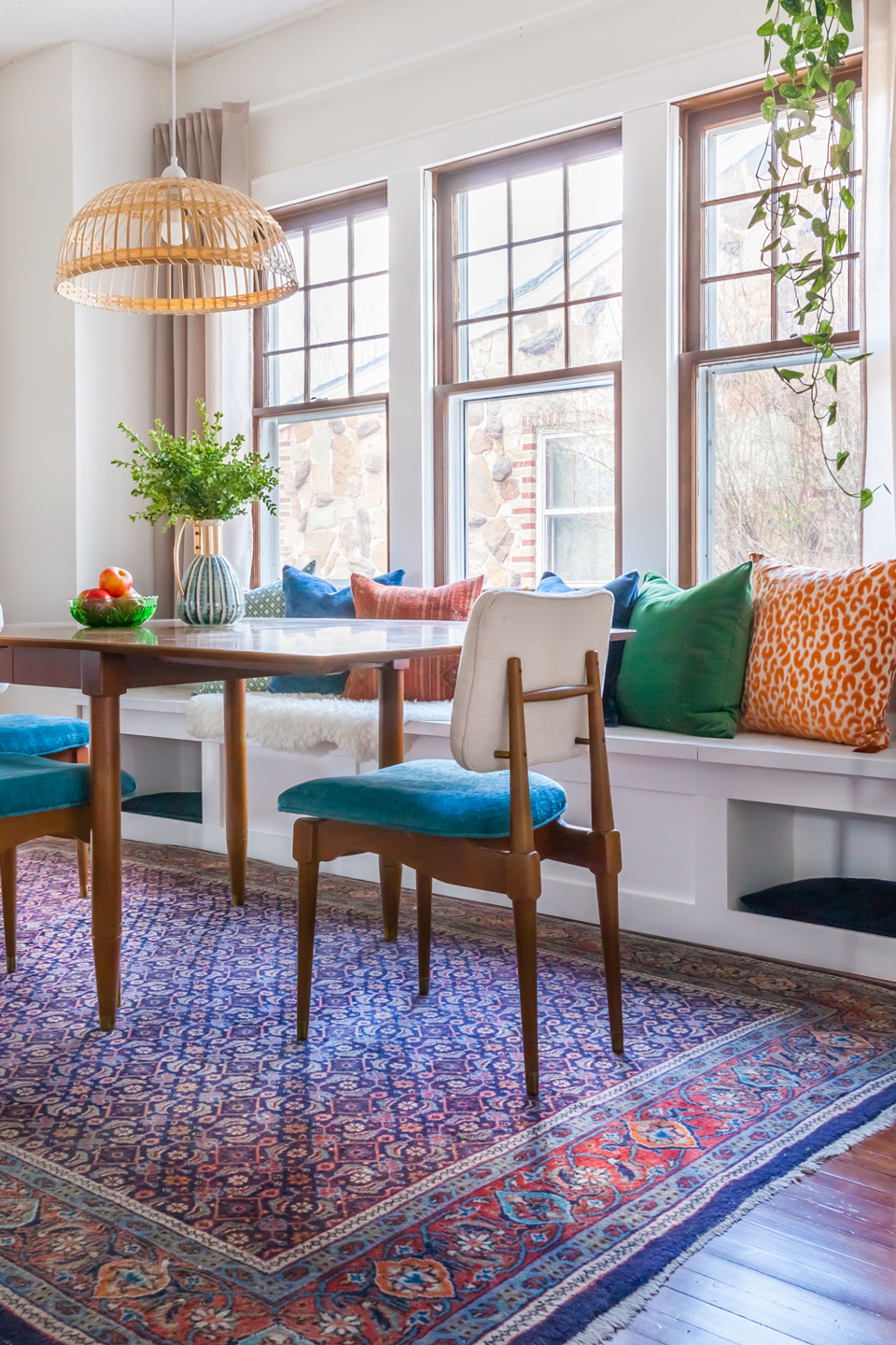 An after image of a dining room with white window seat