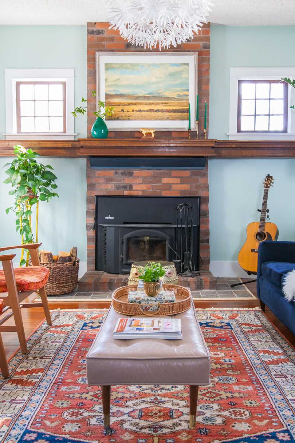 An after image of light blue living room w/ brick fireplace