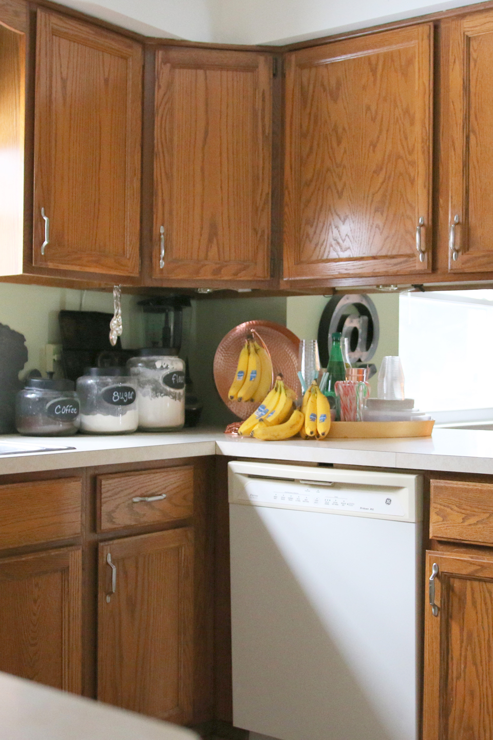 A before image of a kitchen with wood cabinets