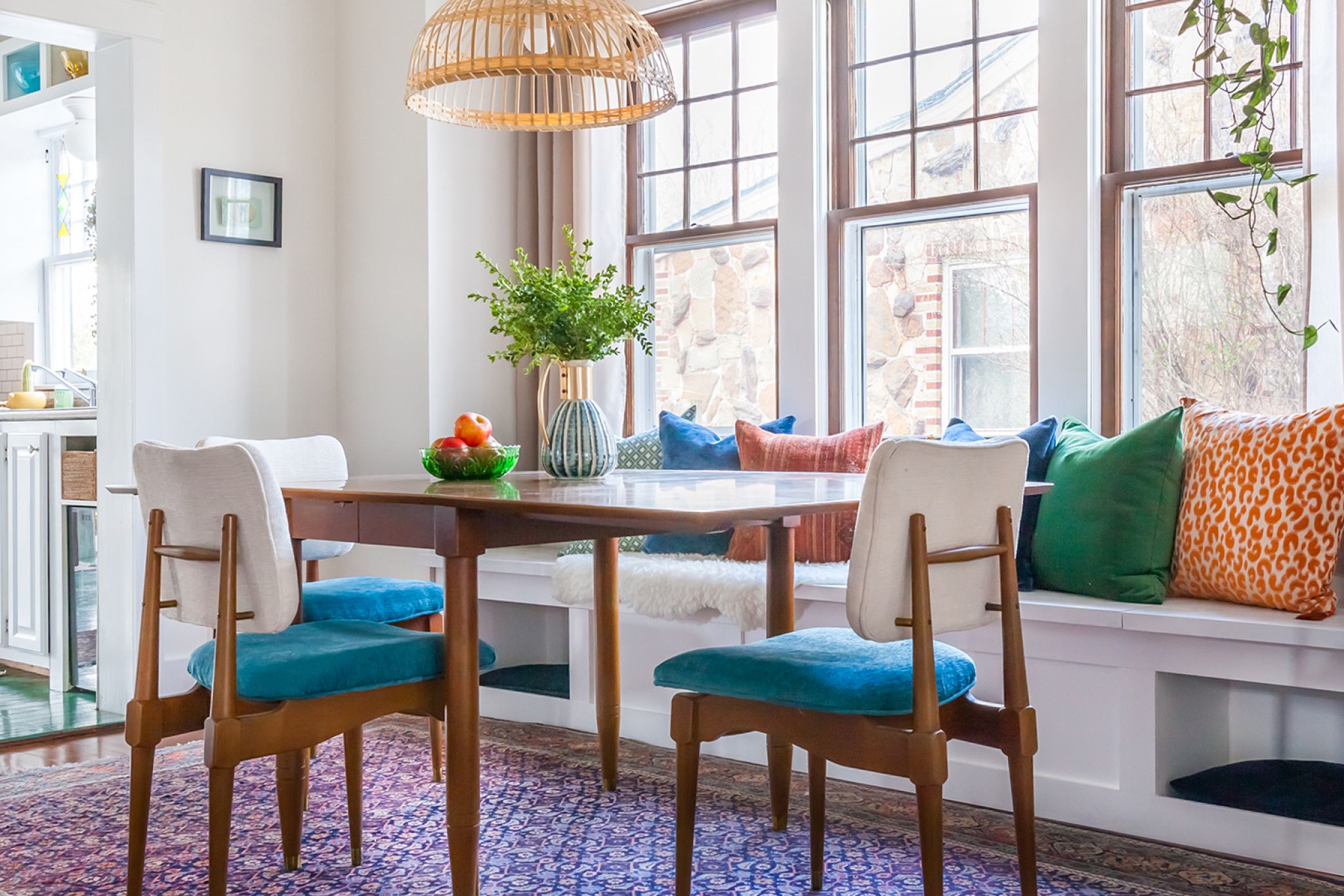 An after image of a dining room with white window seat