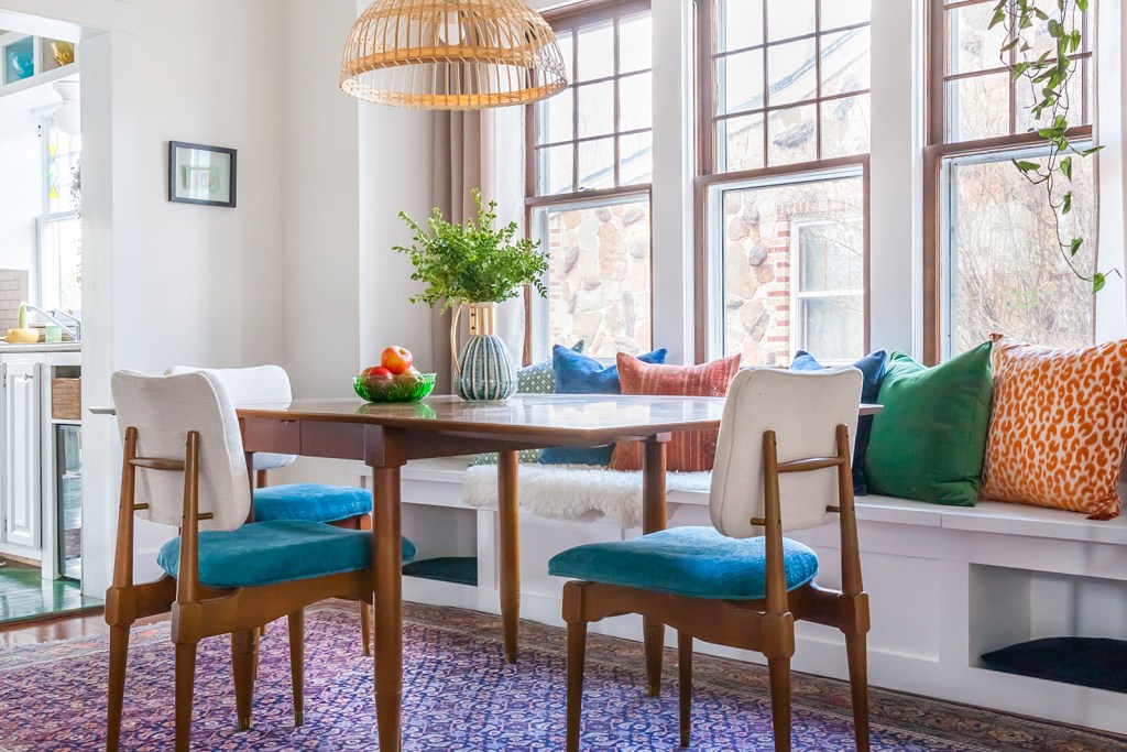 An after image of a dining room with white window seat