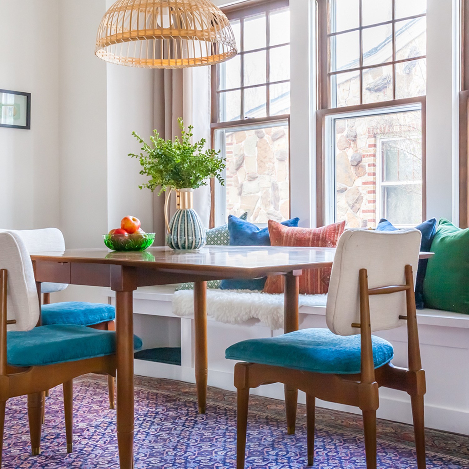 An after image of a dining room with white window seat