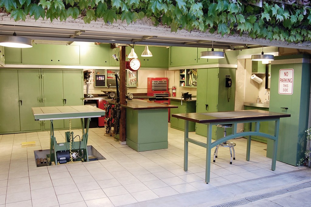 Open garage door with green cabinetry