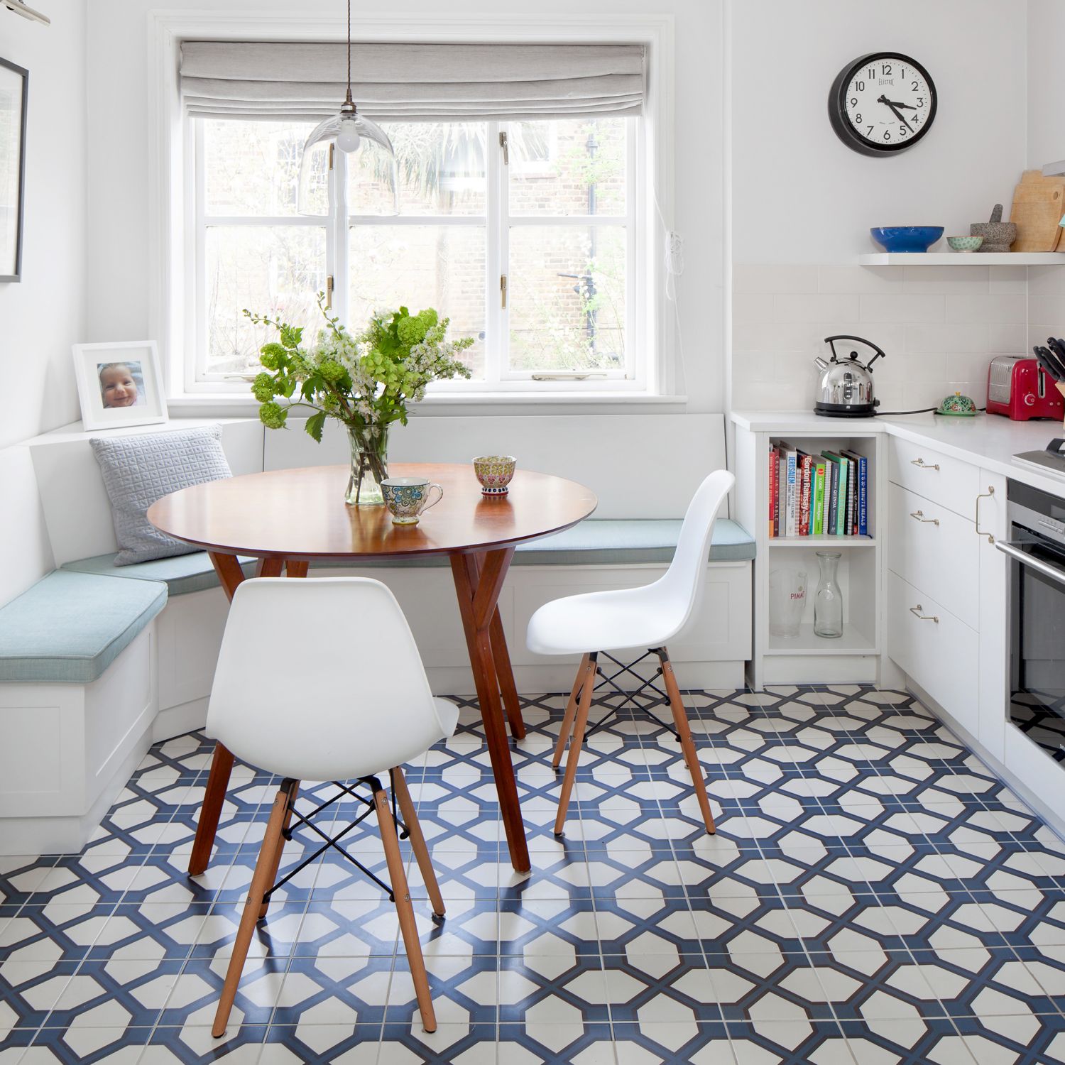 A white contemporary kitchen with blue and white glazed tile