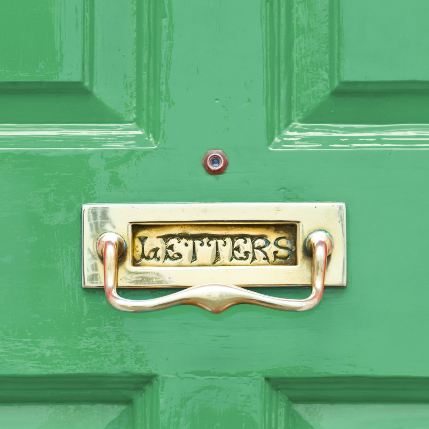 Bright green wood entry door with built-in mailbox