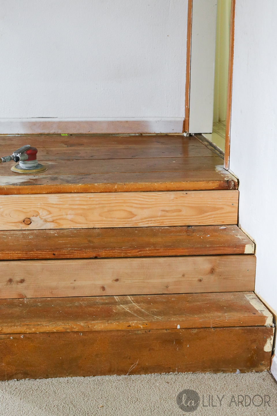 A small wood staircase in a garage