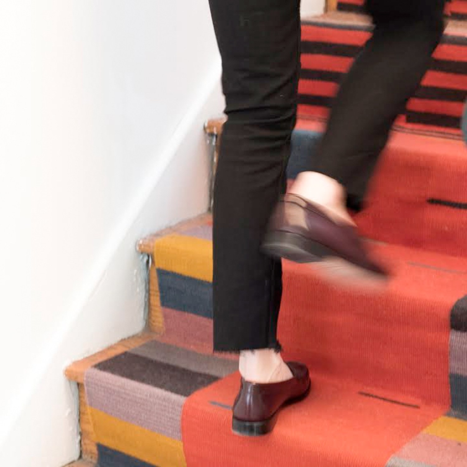 Woman walking up stairs with her custom runner