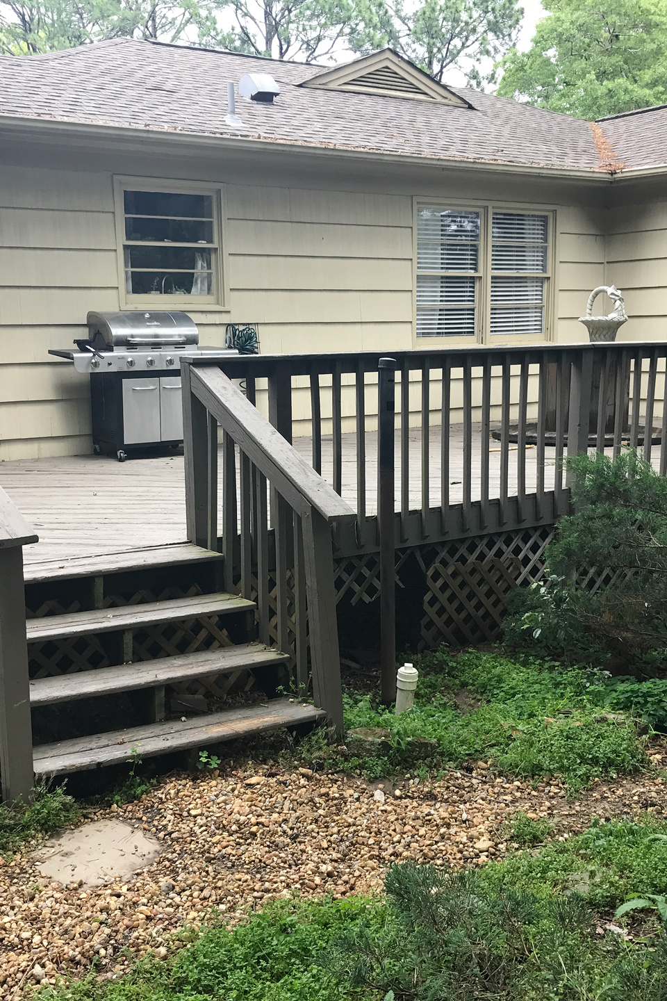 A before image of an old deck in a backyard