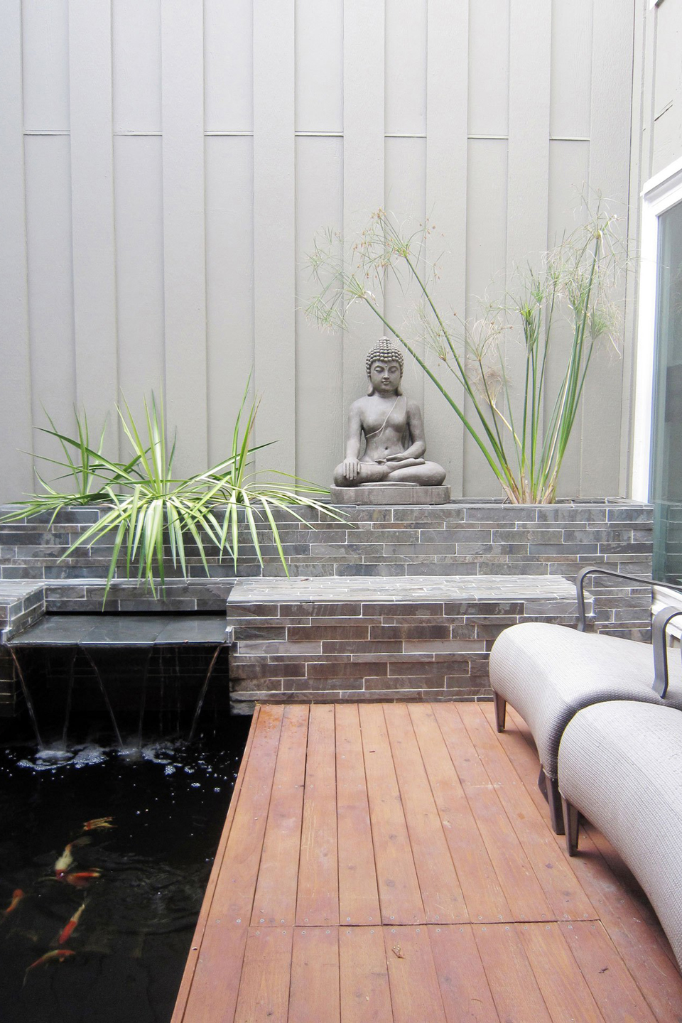 An after image of a small backyard with a fountain