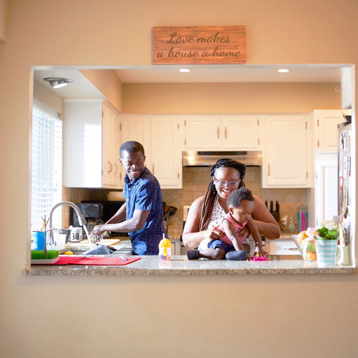 Anthony Tucker and Sammy Kallay with their son in kitchen