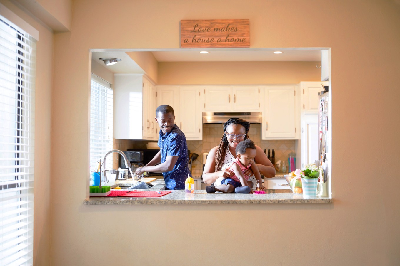 Anthony Tucker and Sammy Kallay with their son in kitchen