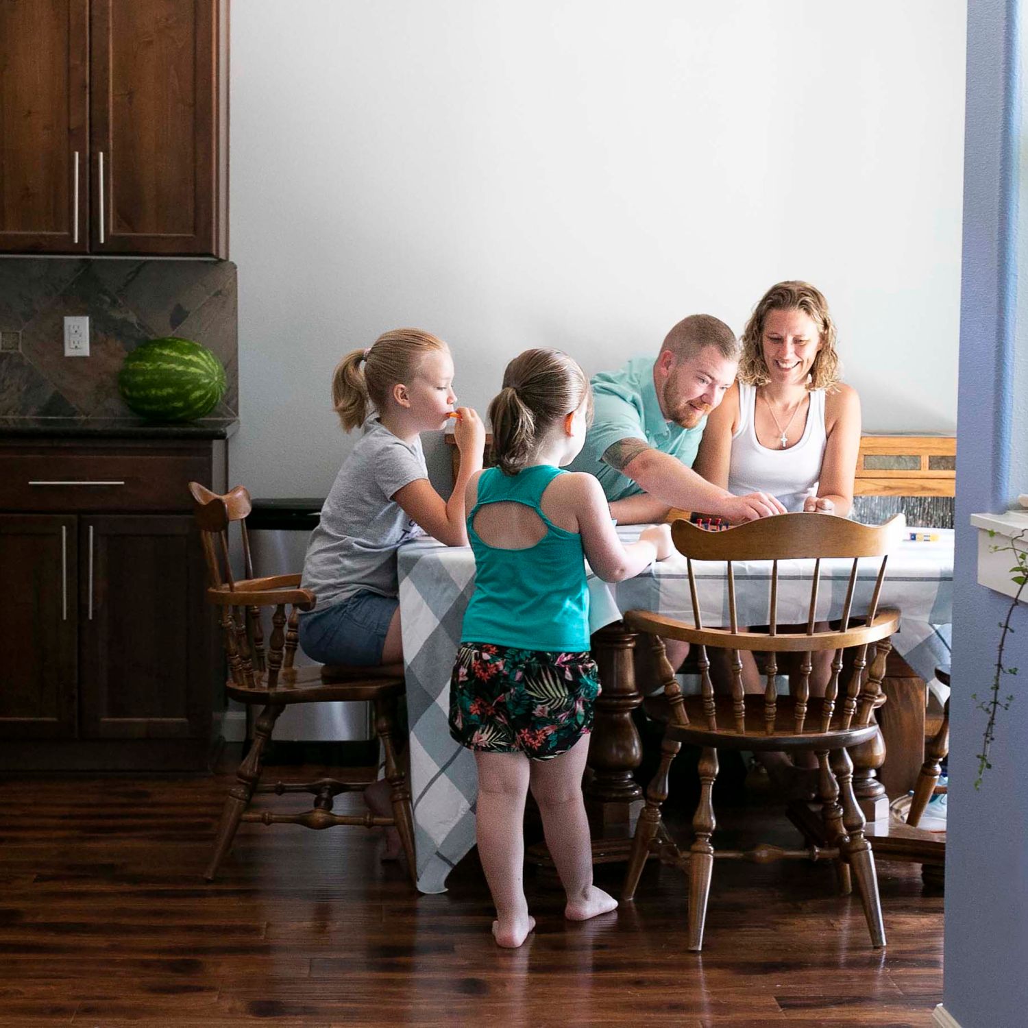 Mark and Jena Boomhower with their daughters at a table.