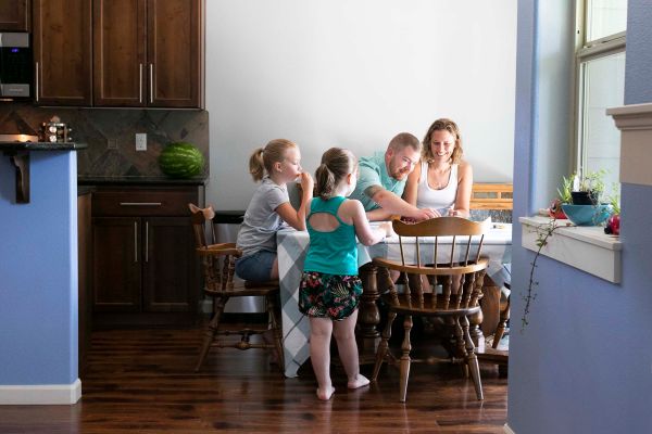 Mark and Jena Boomhower with their daughters at a table.