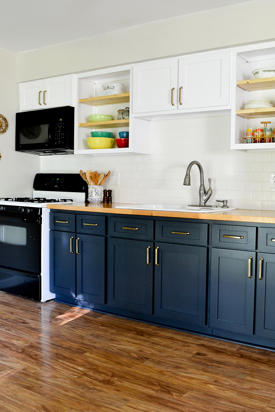 Blue and white cabinet doors in kitchen with open shelves