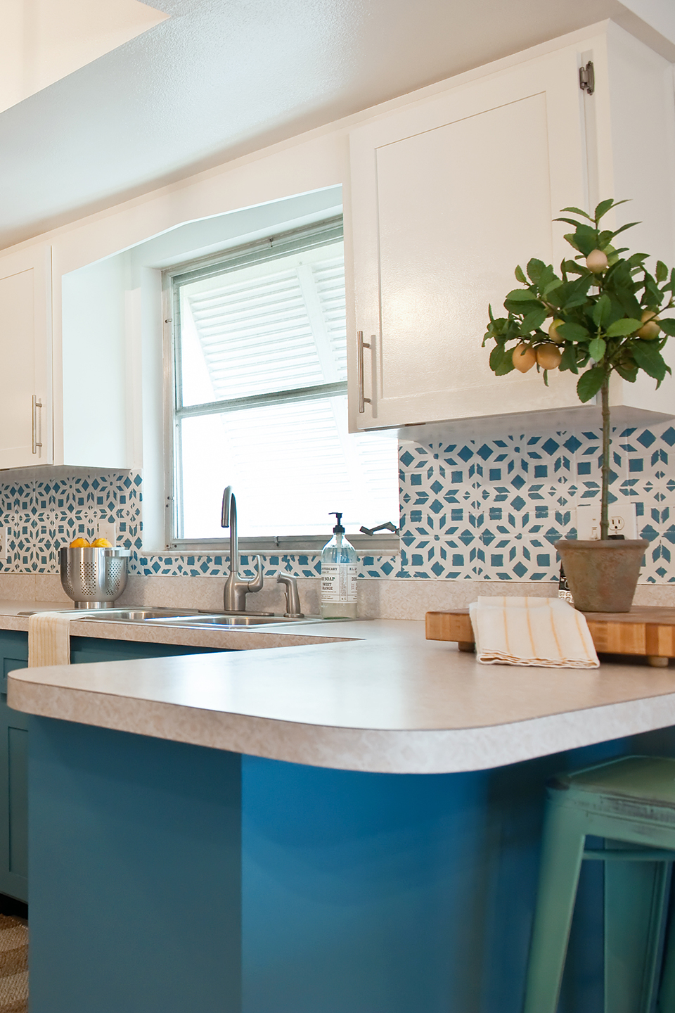 Blue and white kitchen with starburst stenciled tile