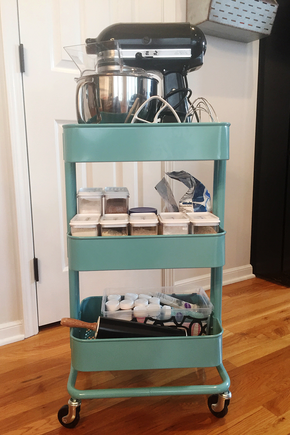 Blue rolling cart with stand mixer and other baking items