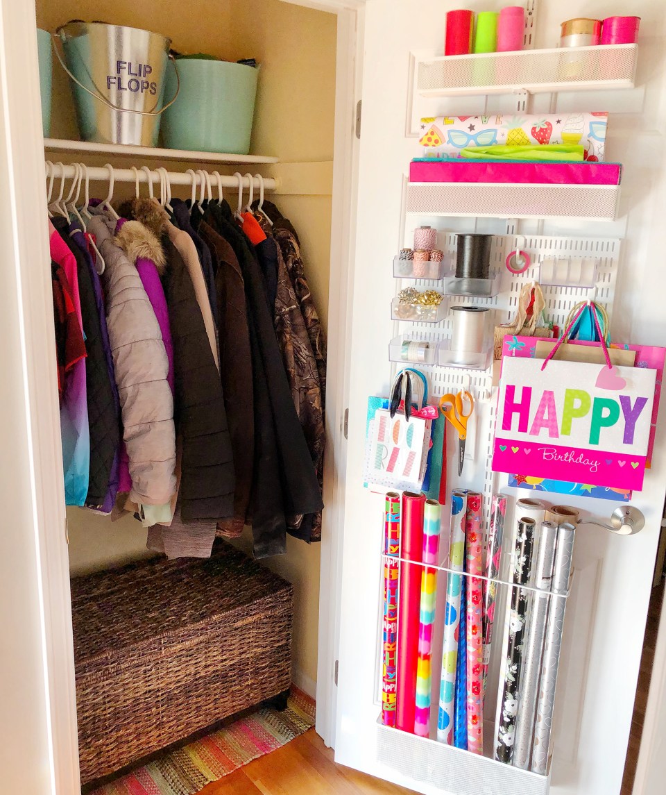 Well organized closet with wrapping paper, boxes and shelves