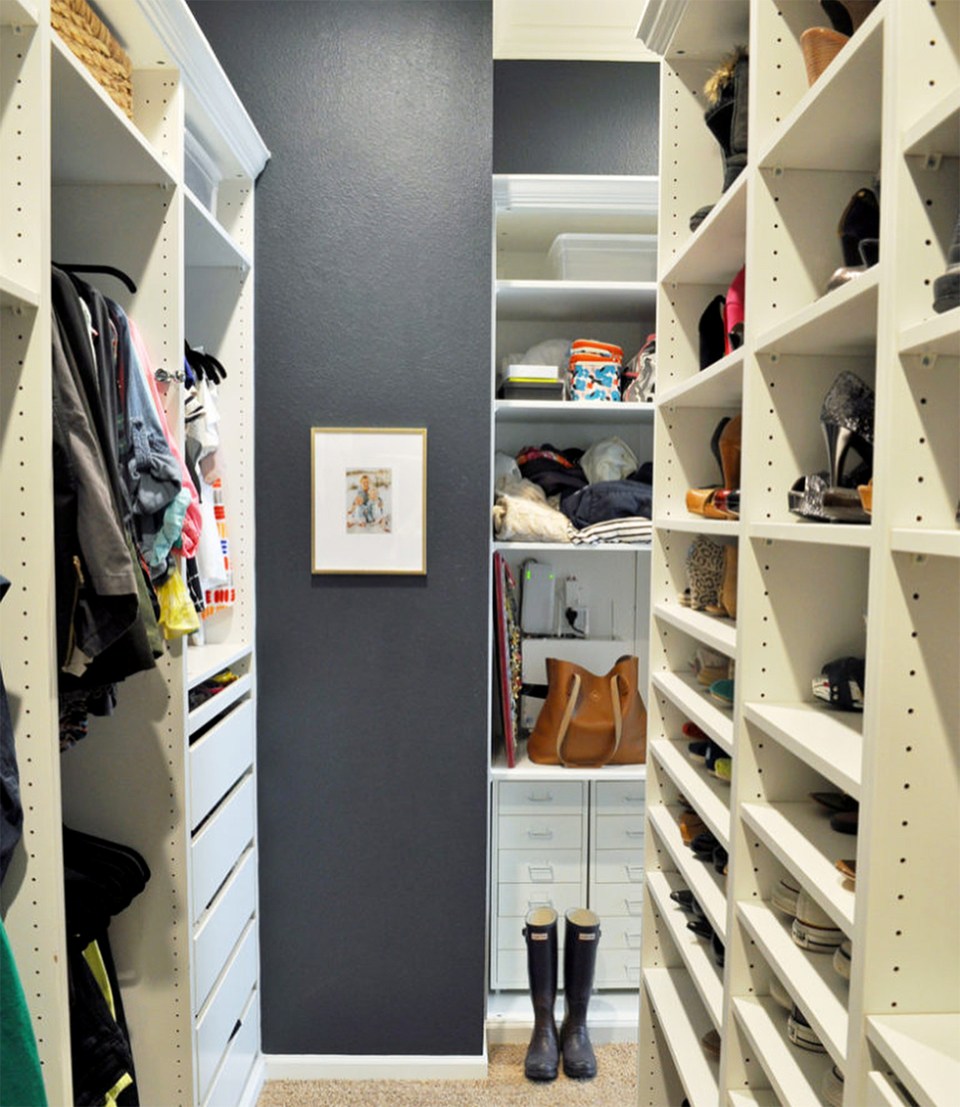 Neatly organized master closet with gray walls