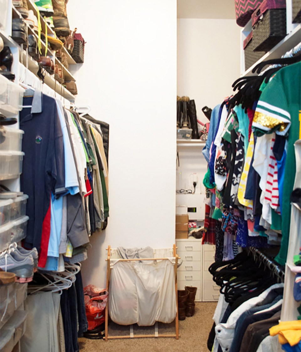 Poorly organized master closet with white walls