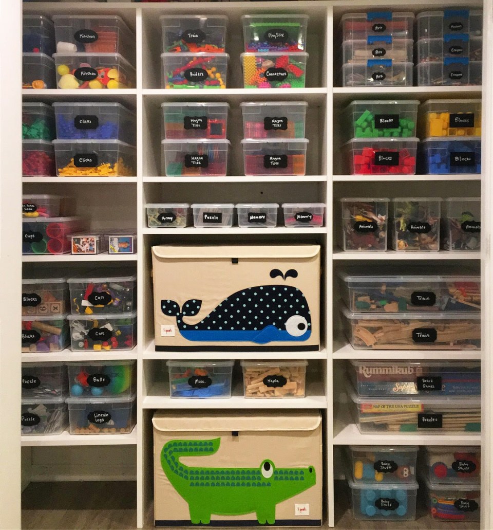 Playroom closet full of toys organized in clear bins