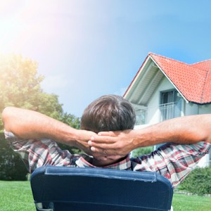 Man relaxing in the back yard of his home
