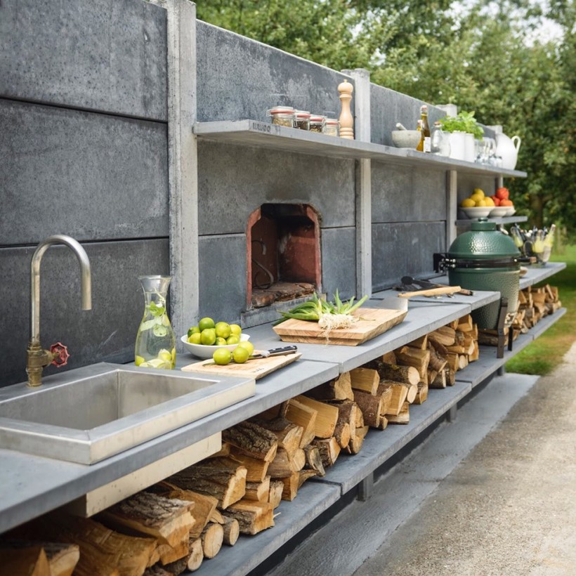 Concrete outdoor kitchen with sink and wood-burning oven