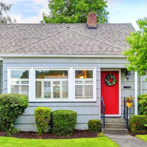 Red front door on a small home