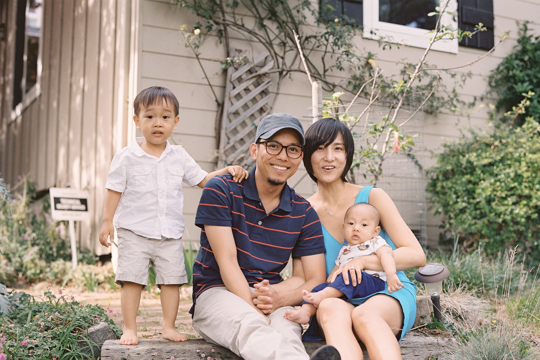 Family sitting outside of their house