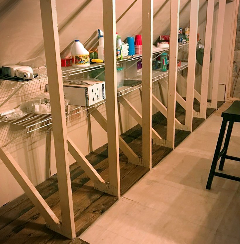 Wire racks placed in between attic rafters for storage