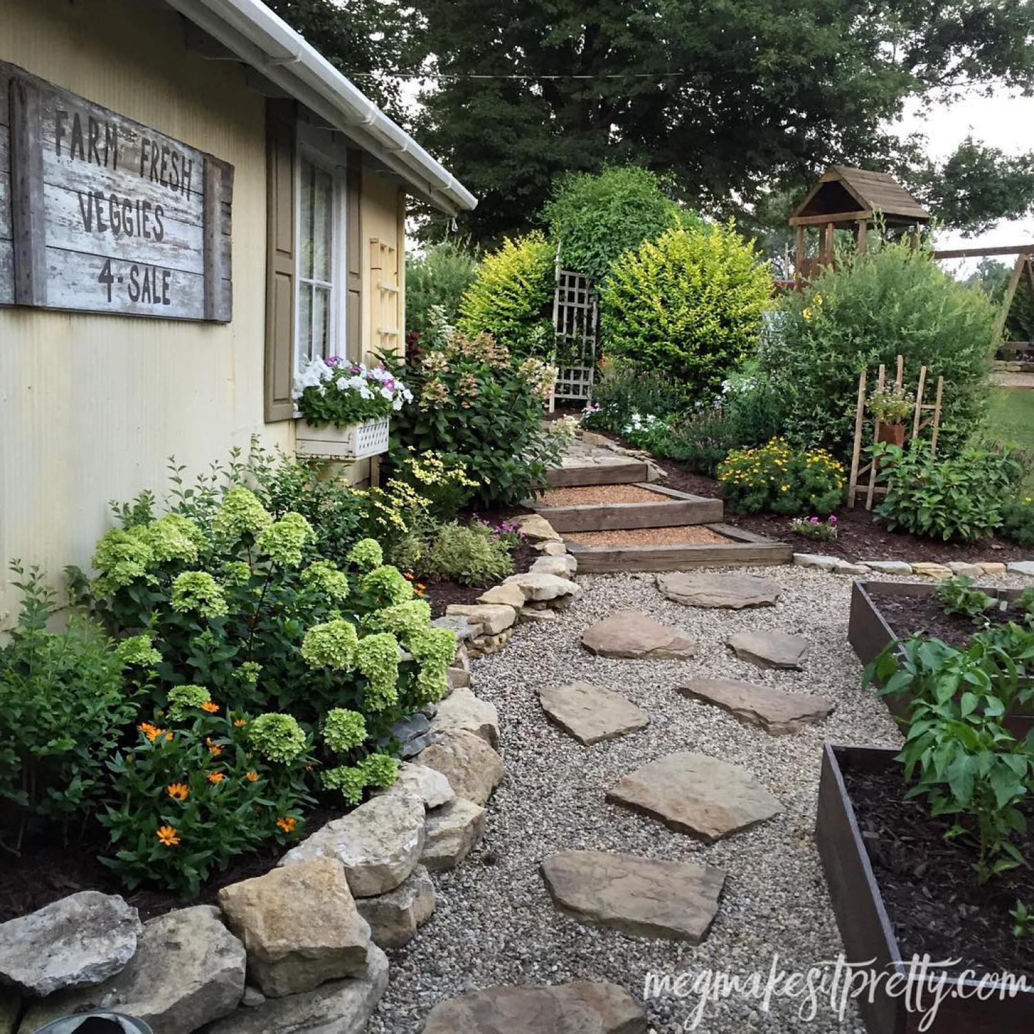 Stone and gravel front walkway to home