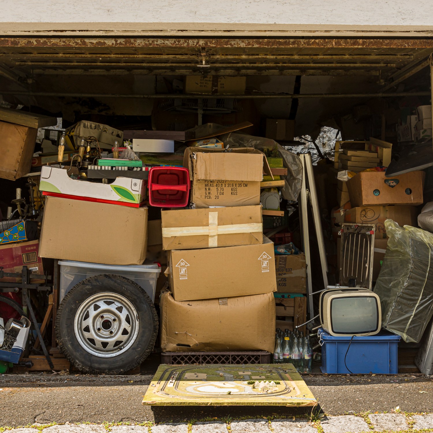 Open garage filled with boxes and old stuff