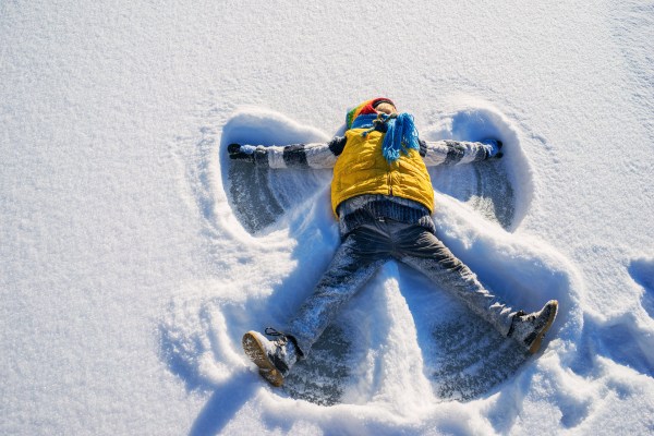 A child making a snow angel.