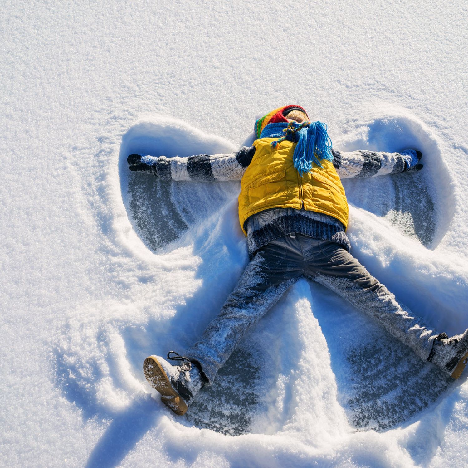 A child making a snow angel.