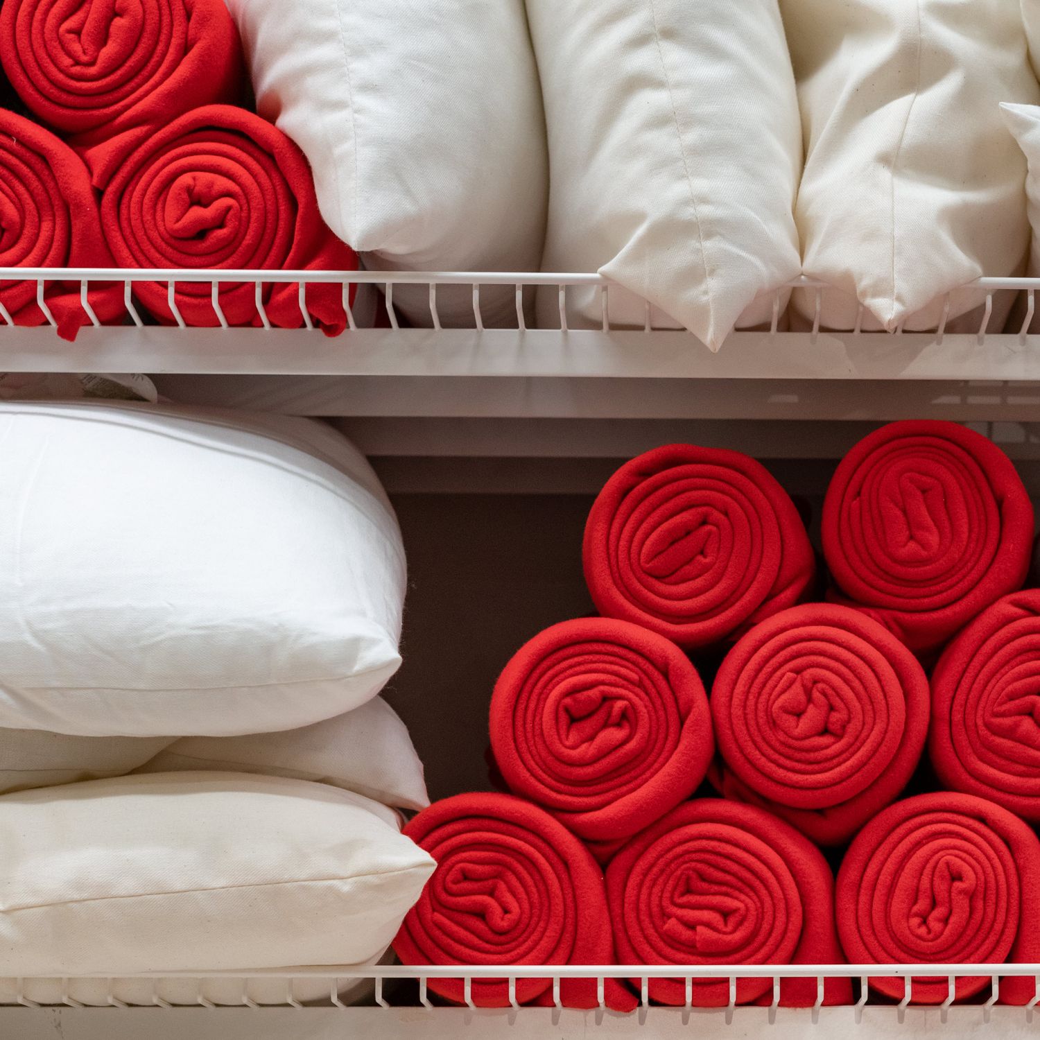 best time to buy things for your home like linens in image of comforters pillows and red blankets