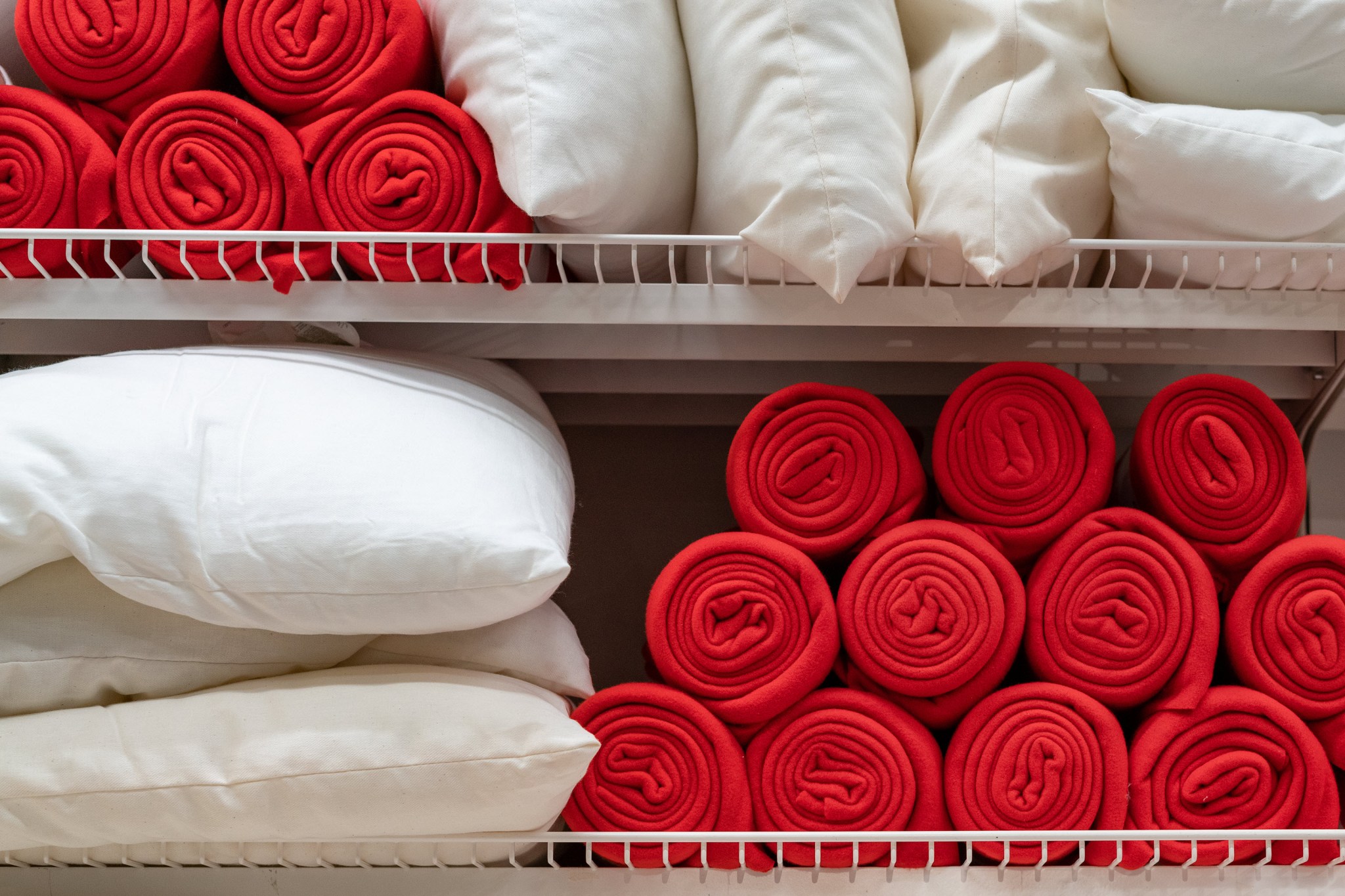 best time to buy things for your home like linens in image of comforters pillows and red blankets