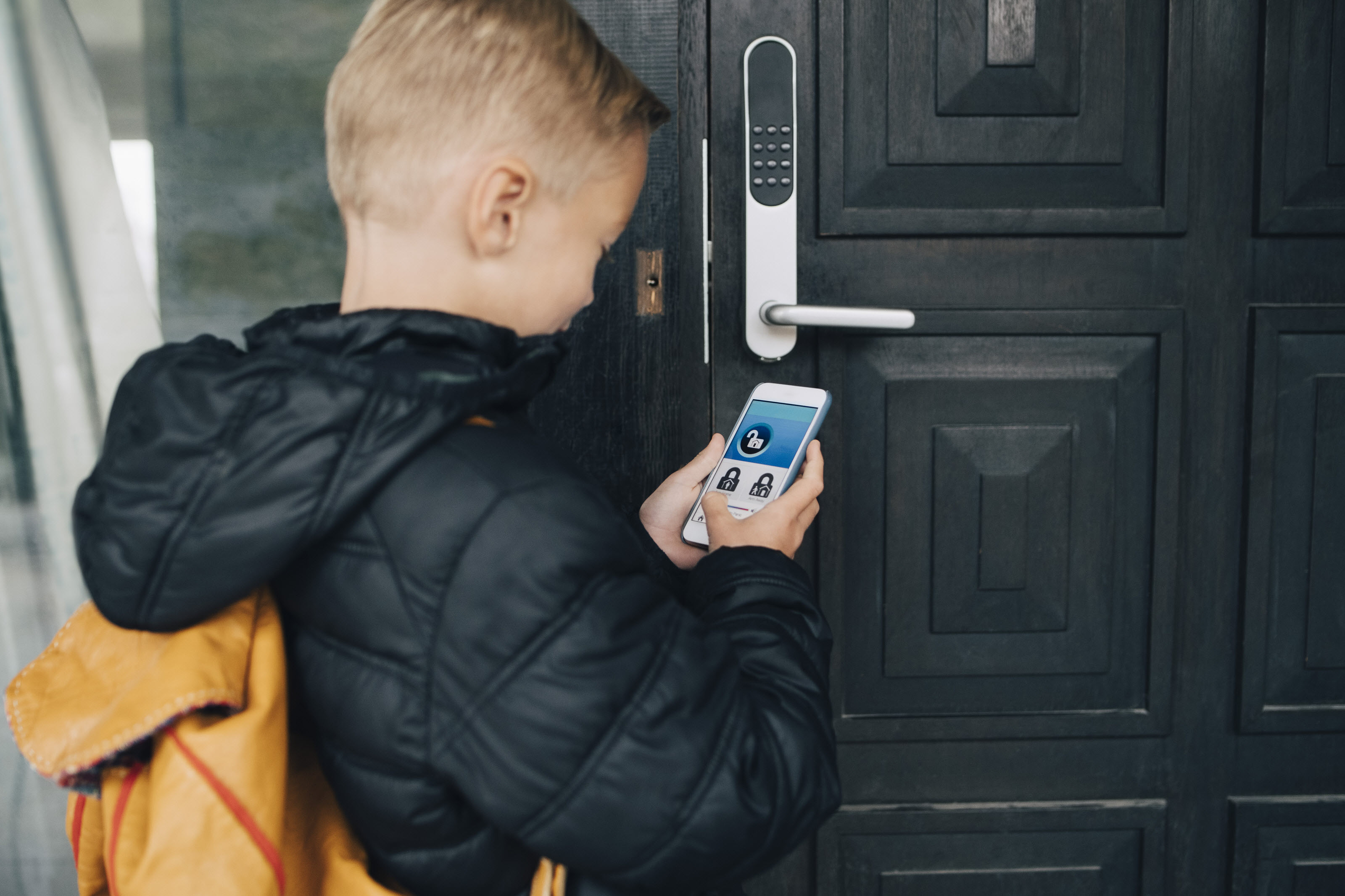 smart home security overview boy using phone smart lock