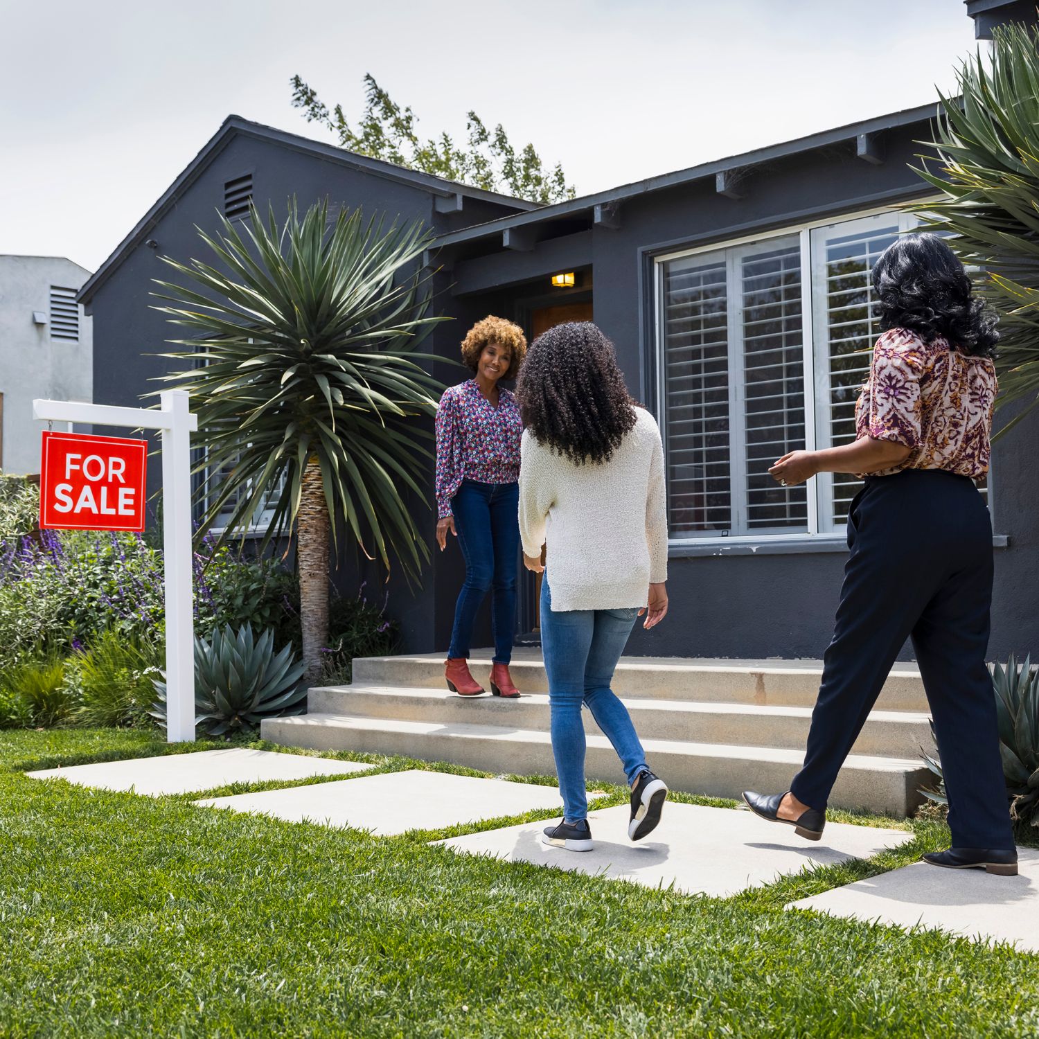 Real estate agent meets family for a tour of a for-sale house.