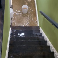 solutions-fixing-wet-basement-flood-water-flowing-down-staircase