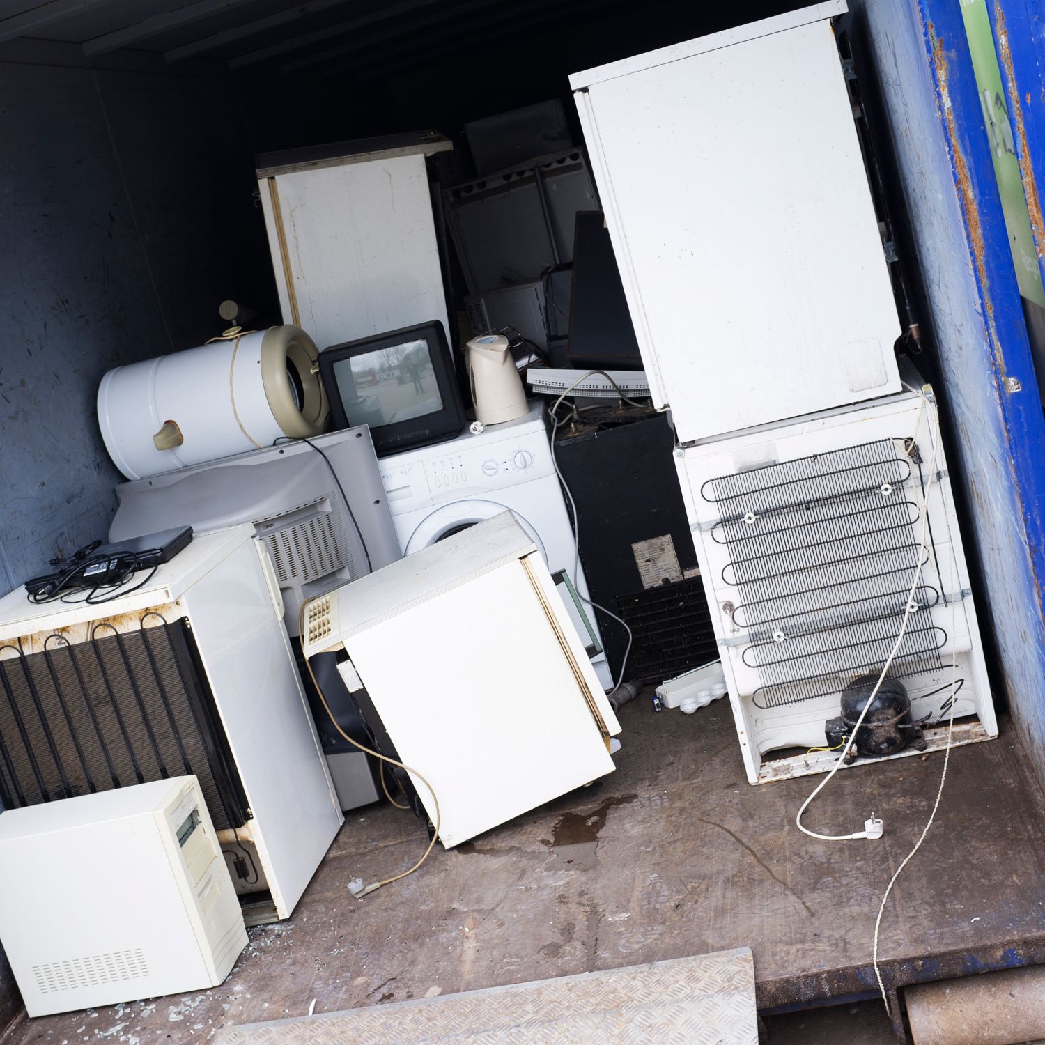 repair replace home maintenance make appliances last longer image of old appliances and fixtures loaded into a blue recycling container