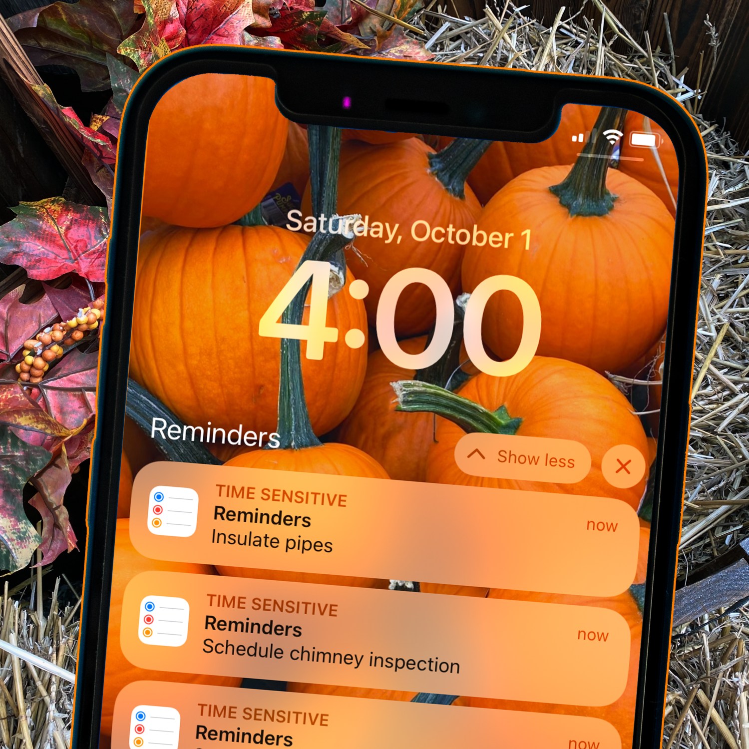 do this now october image of hay and fall leaves in the background with a cellphone that has a background image of colorful pumpkins and reminders set for fall autumn tasks