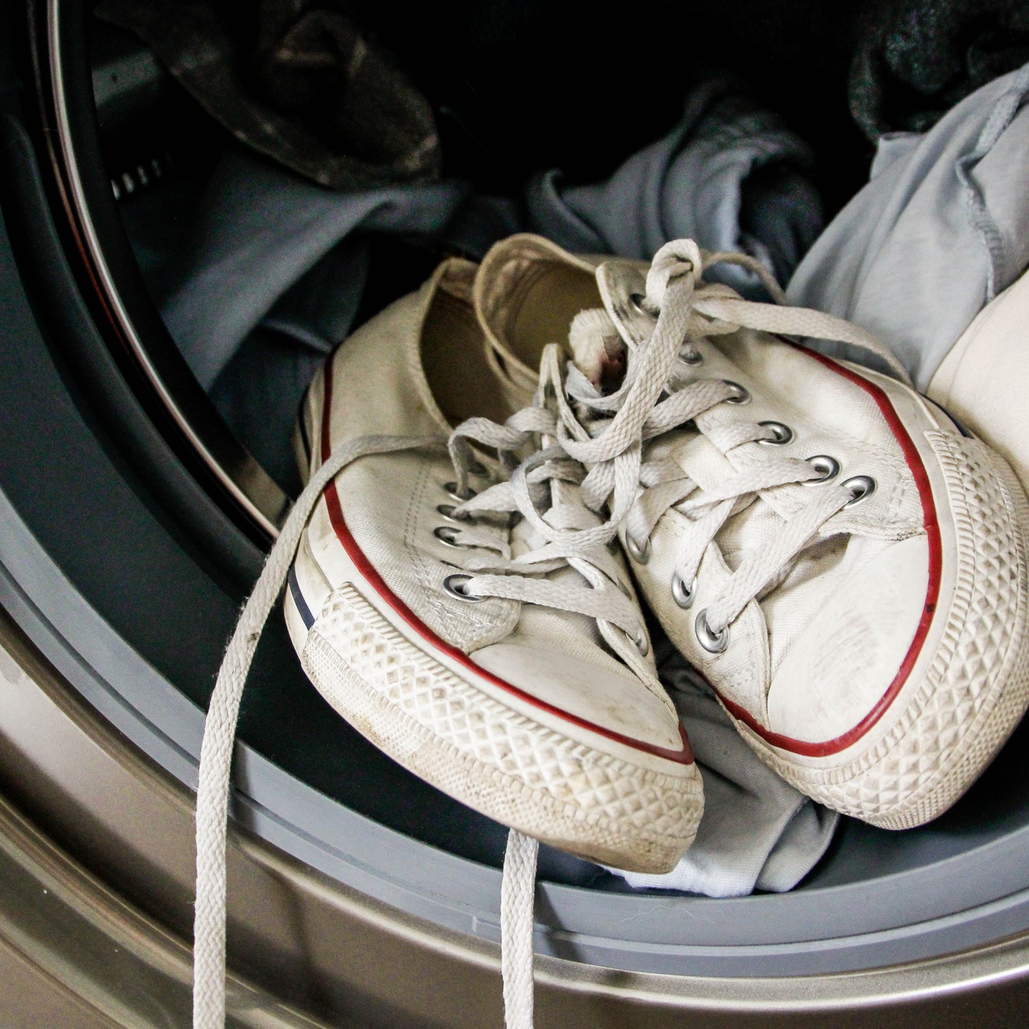 wash just about anything image of dirty white sneakers and t-shirts in a front load washing machine