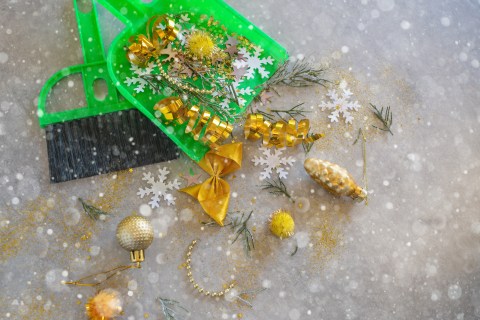 post holiday home cleaning green brush and dustpan with gold decorations ornaments bows glitter