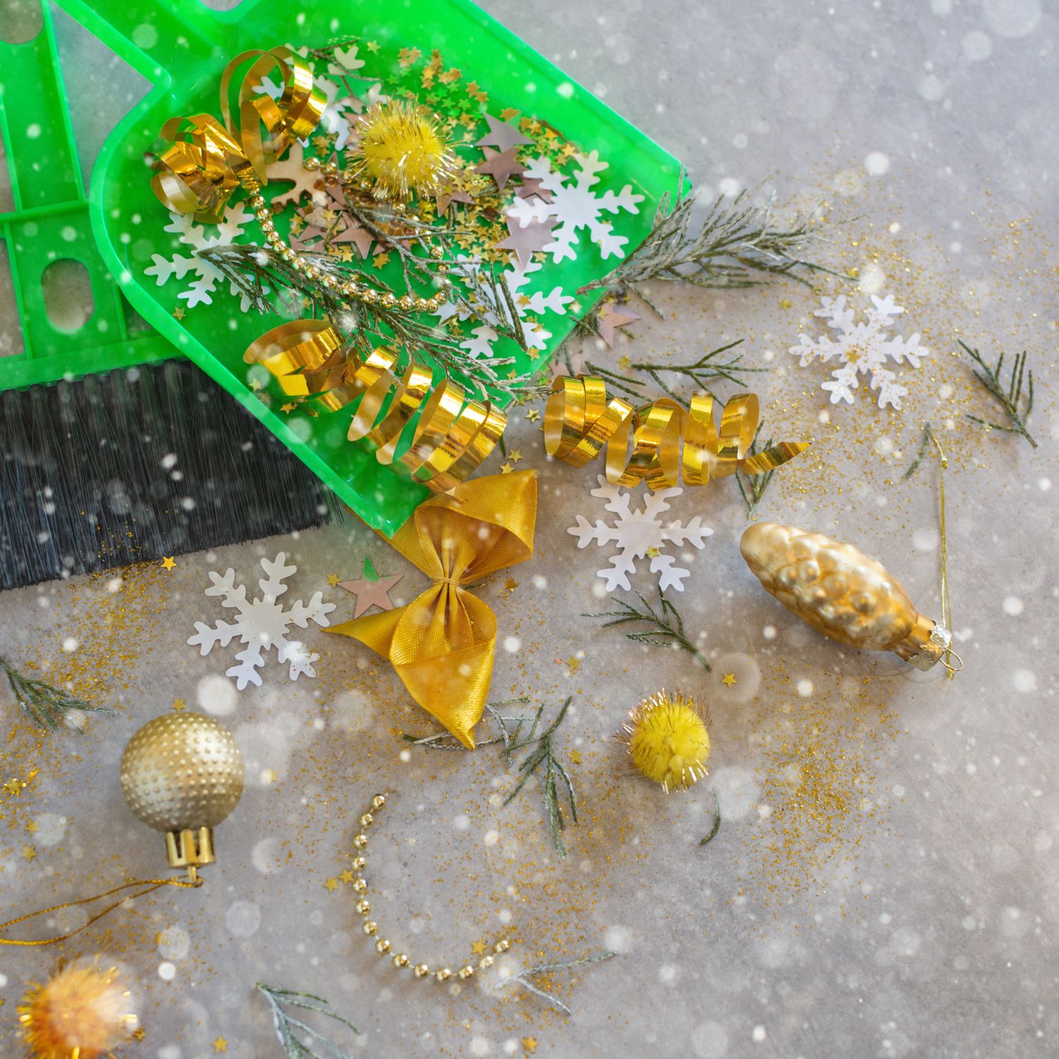 post holiday home cleaning green brush and dustpan with gold decorations ornaments bows glitter