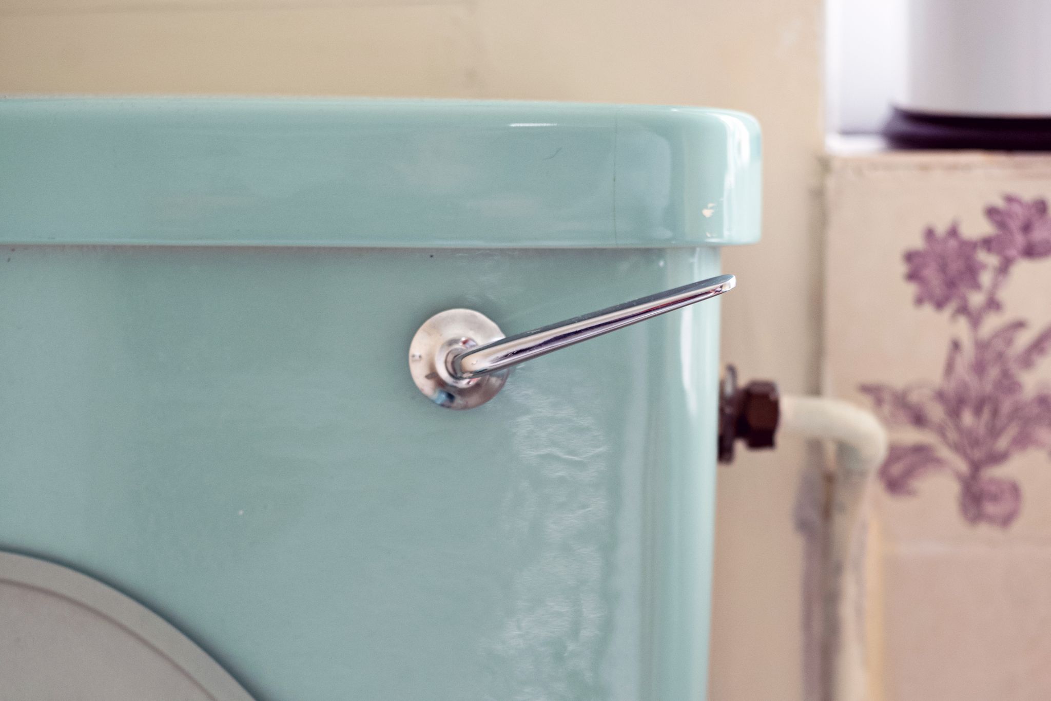 close up of retro turquoise toilet tank and flush handle fix sweaty condensation toilet