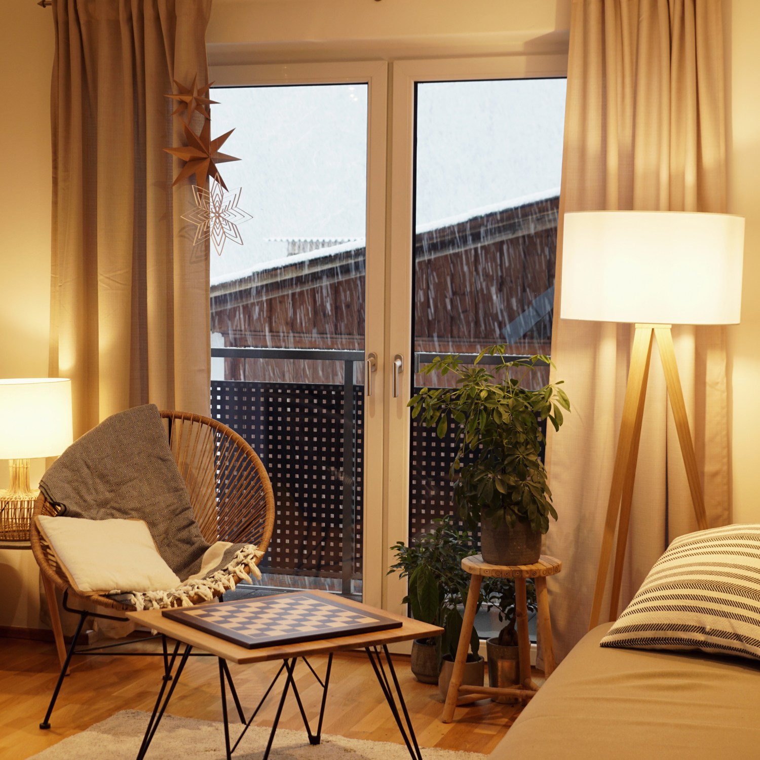 light cozy Scandinavian style living room ehanced in winter with comfy sofa coffe table and warm lamps