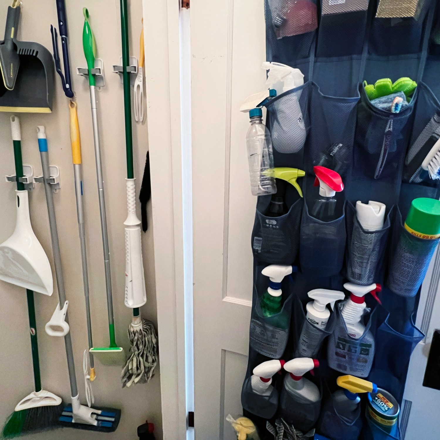 home cleaning products organized in hallway to basement shoe caddy on door broom mops dusters hang on wall