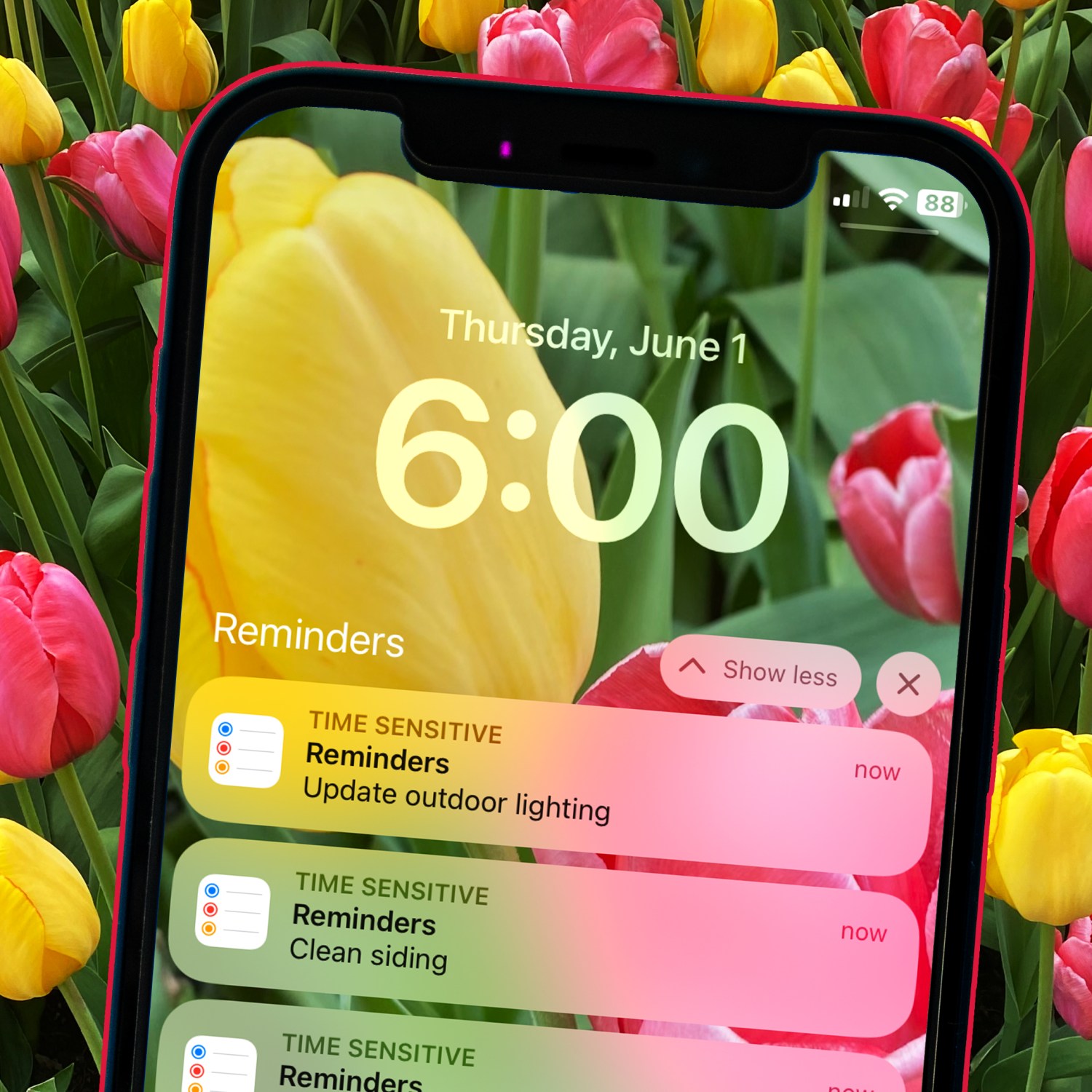 cell phone reminder of home maintenance tasks to complete now in june with a background of pink and yellow tulips