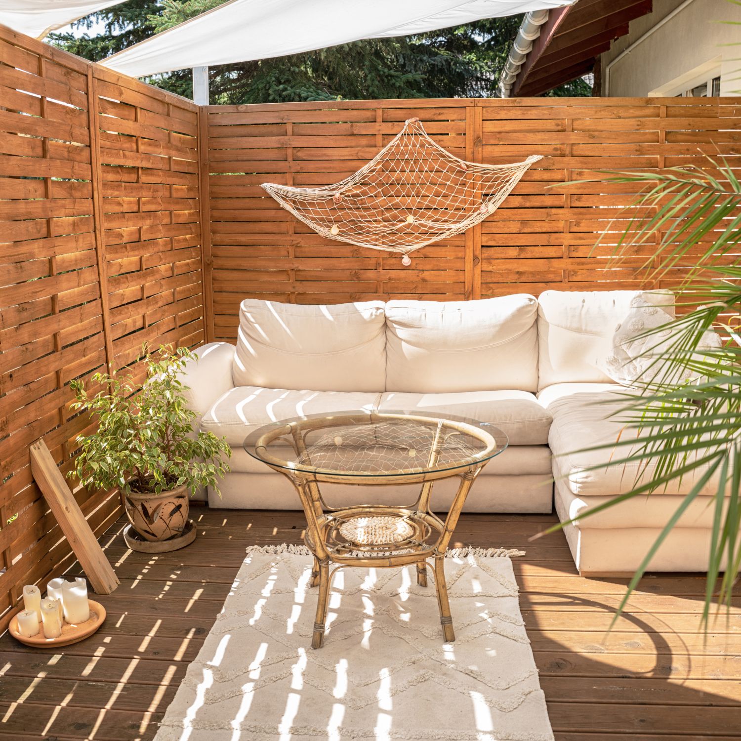 backyard problem solutions photo of patio with wooden privacy fence, comfy furniture and green plants