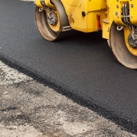New asphalt road being paved. Road asphalt cost.