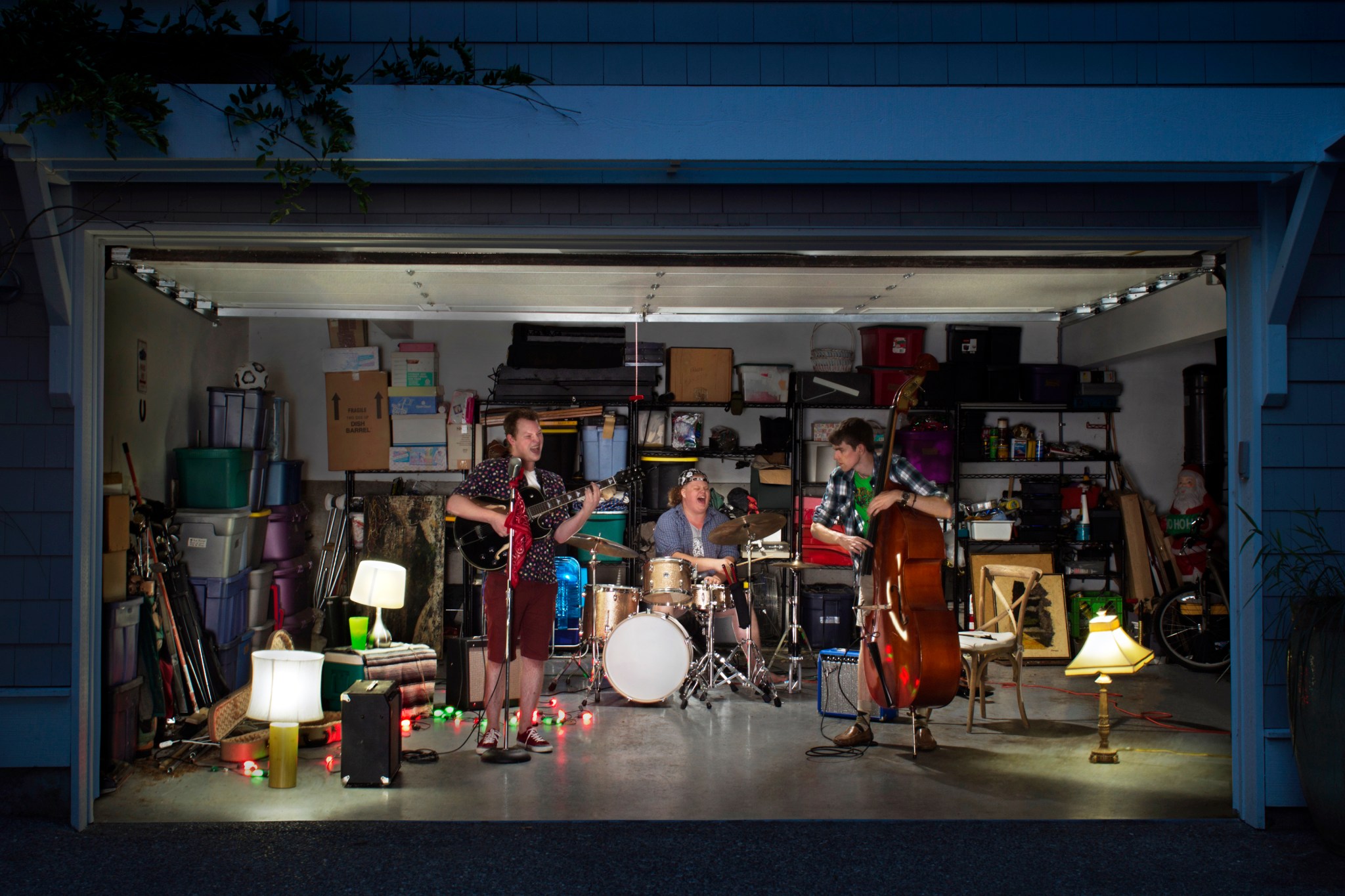 Band playing in garage with several lights